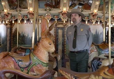 NPS Ranger with carousel giving virtual tour
