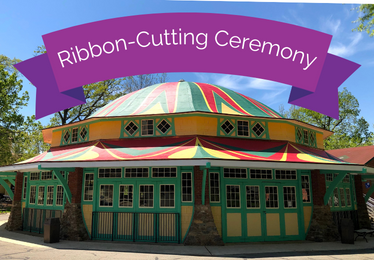 Ribbon Cutting Ceremony logo with purple ribbon over colorful carousel roof