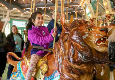 girl rides the carousel