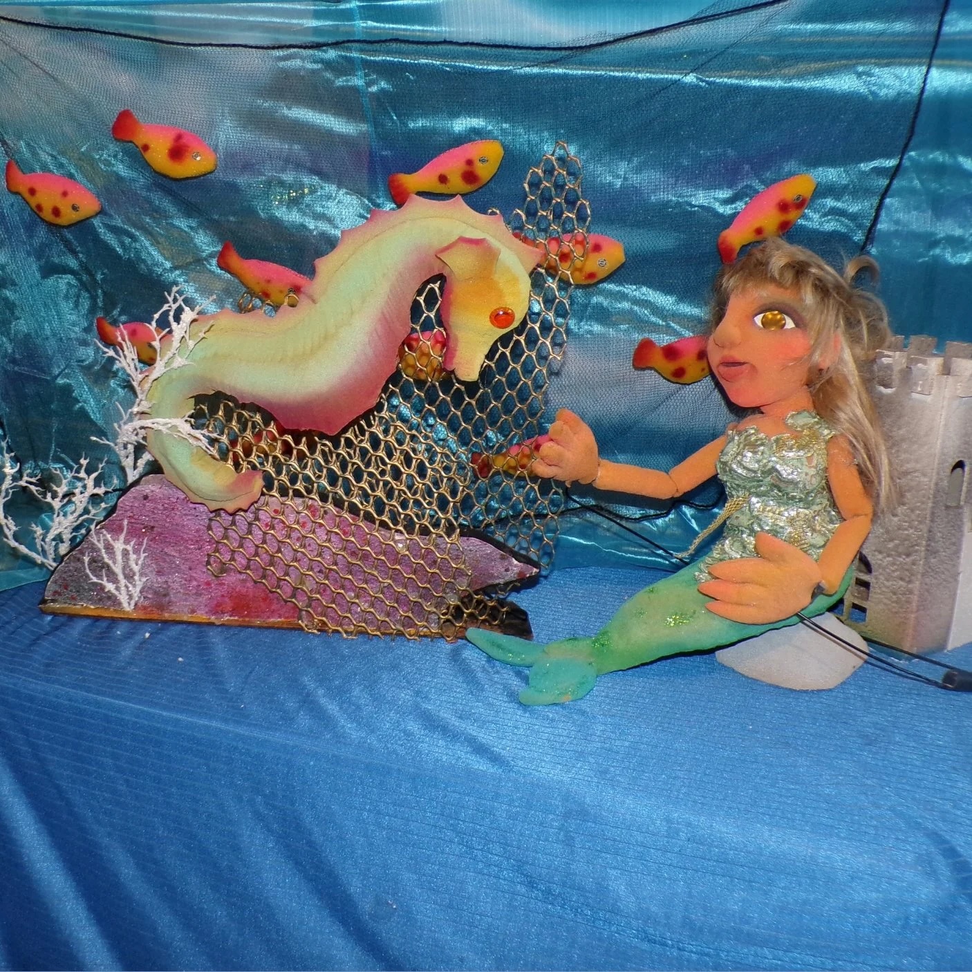 A mermaid and seahorse puppet