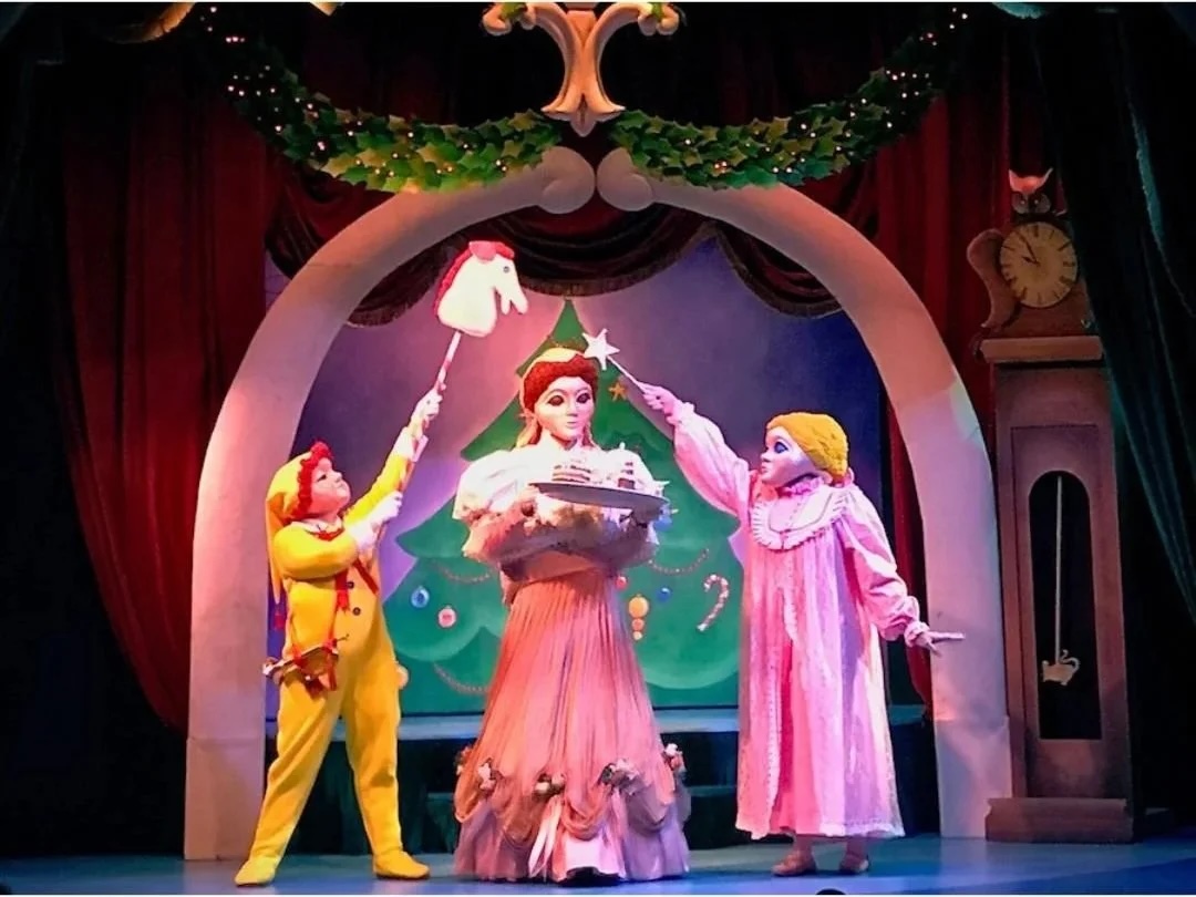 Three puppets on a stage