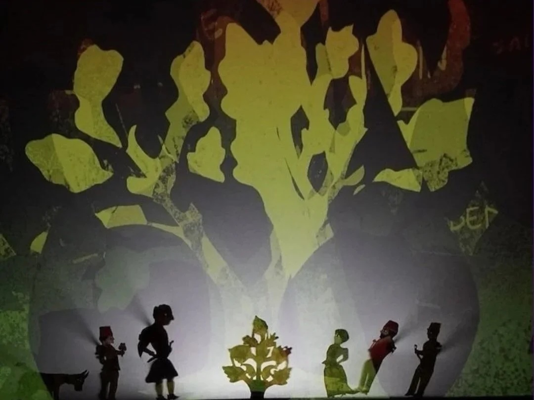 An image of shadow puppets in a forest scene