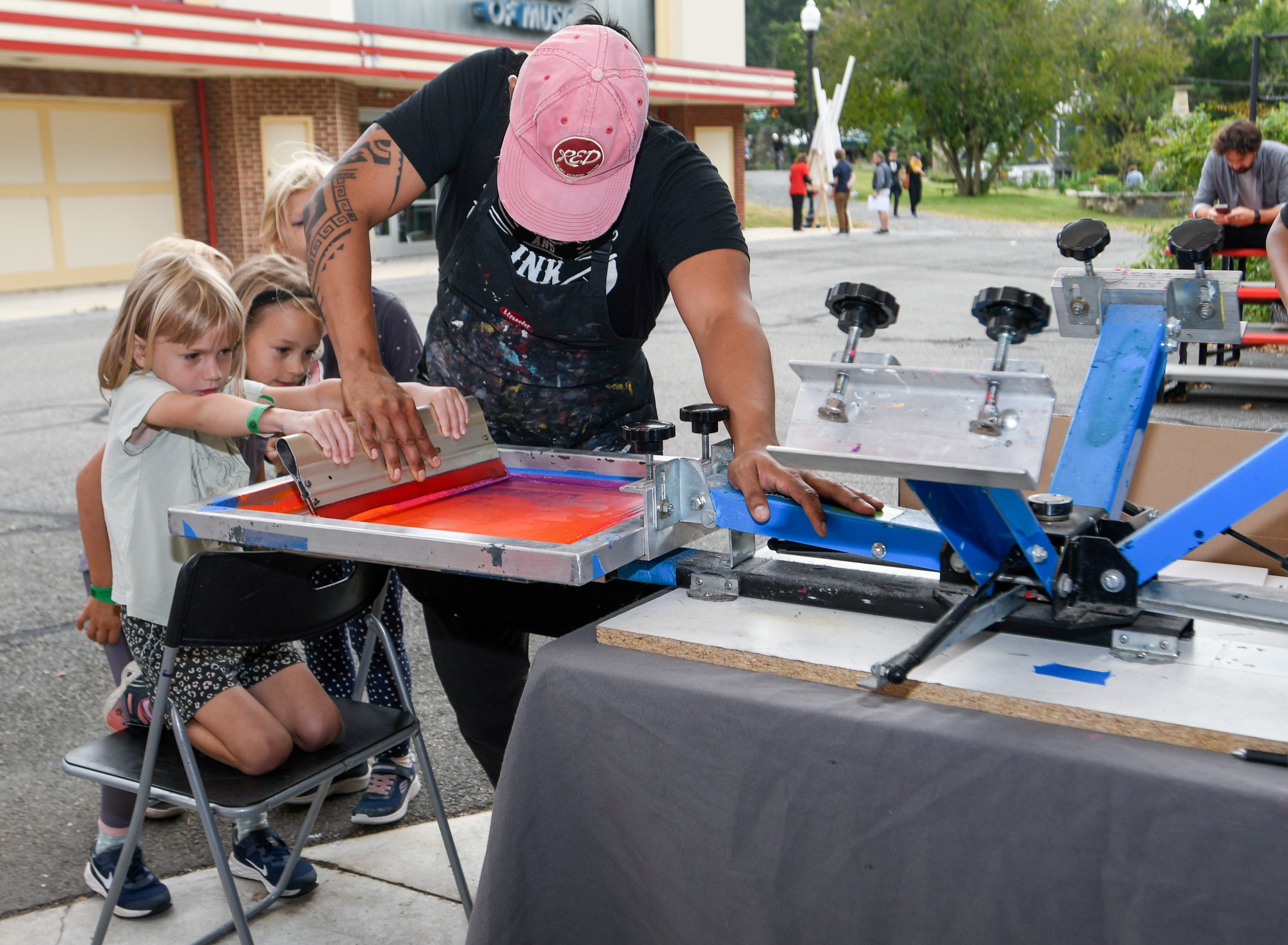 a child pulls a screen with help from an adult