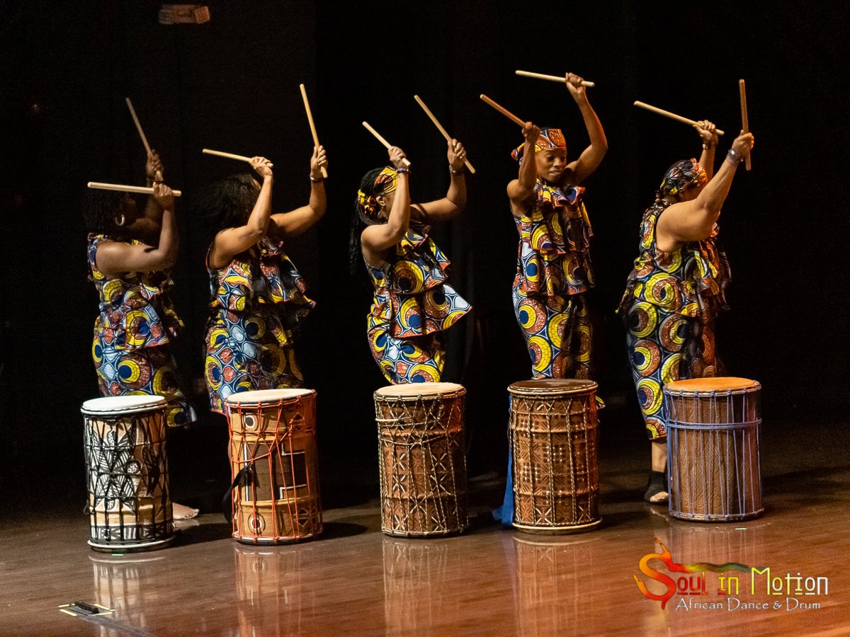Drummers raise their drumsticks