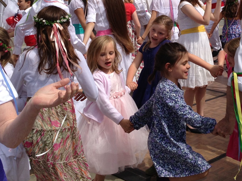 young girls dancing with spring flower crowns in their hair