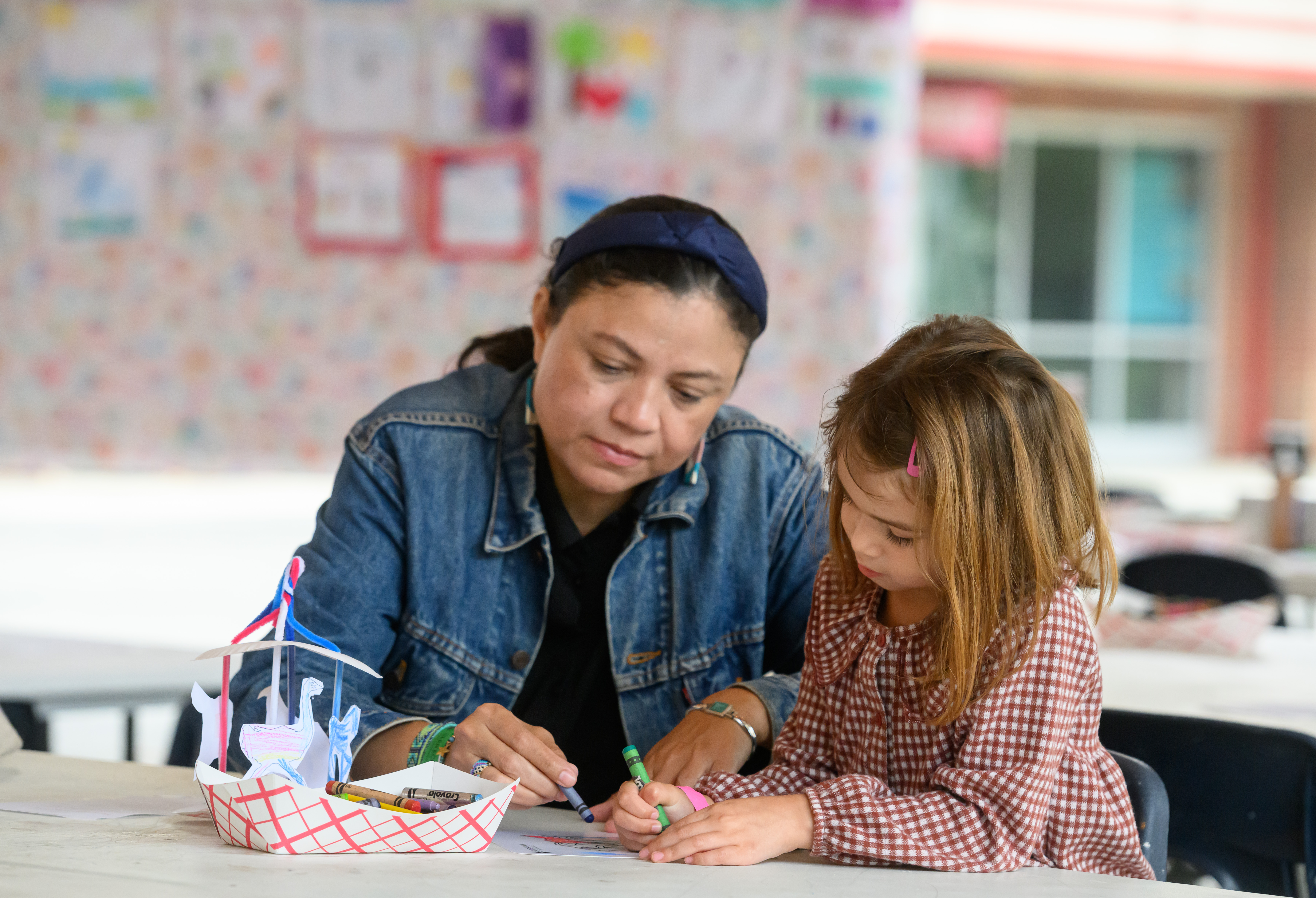 A parent and child make arts and crafts together