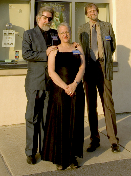 Two men and one woman standing in front of the Puppet Co.