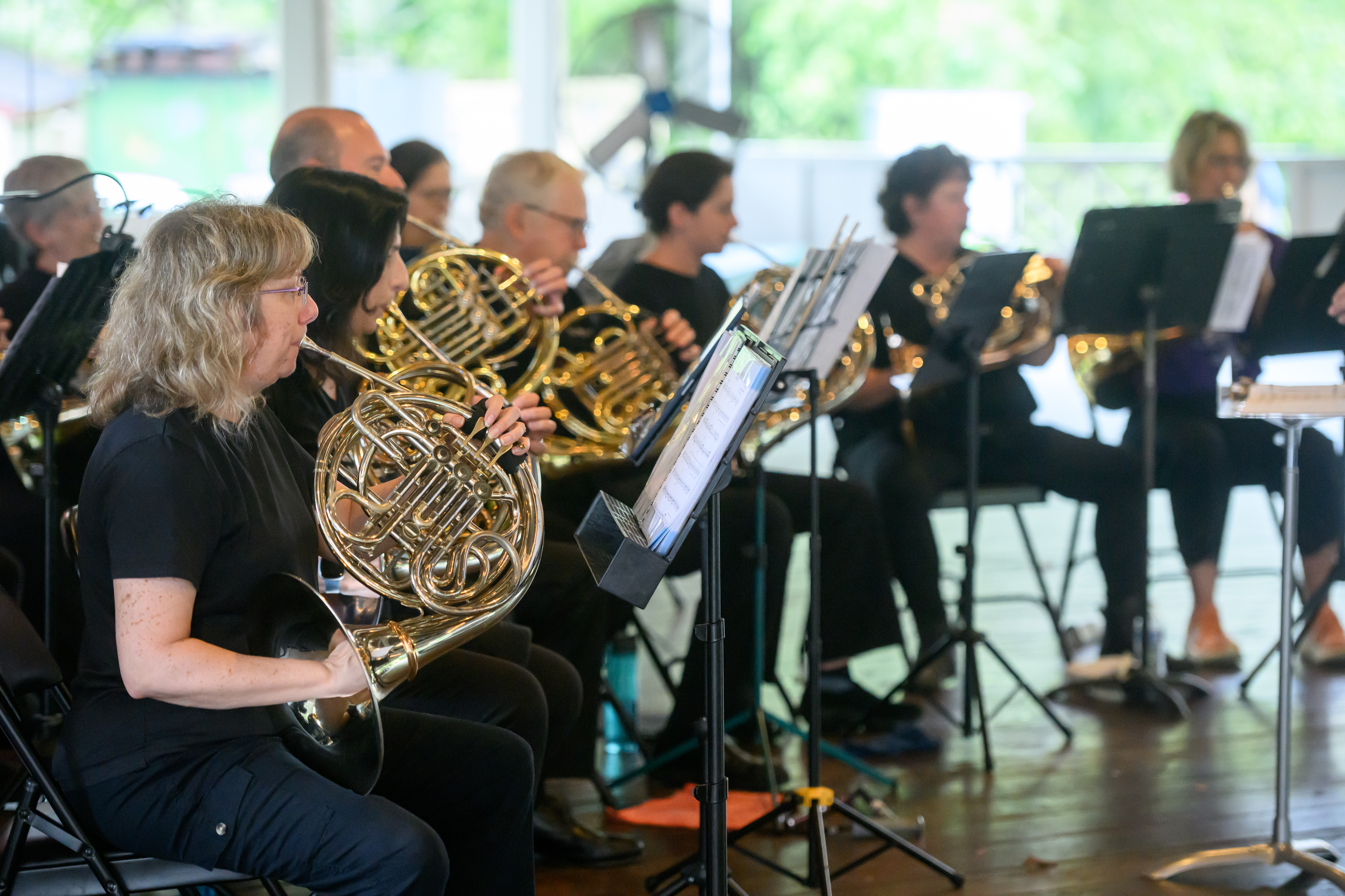 Horn players in a pavilion