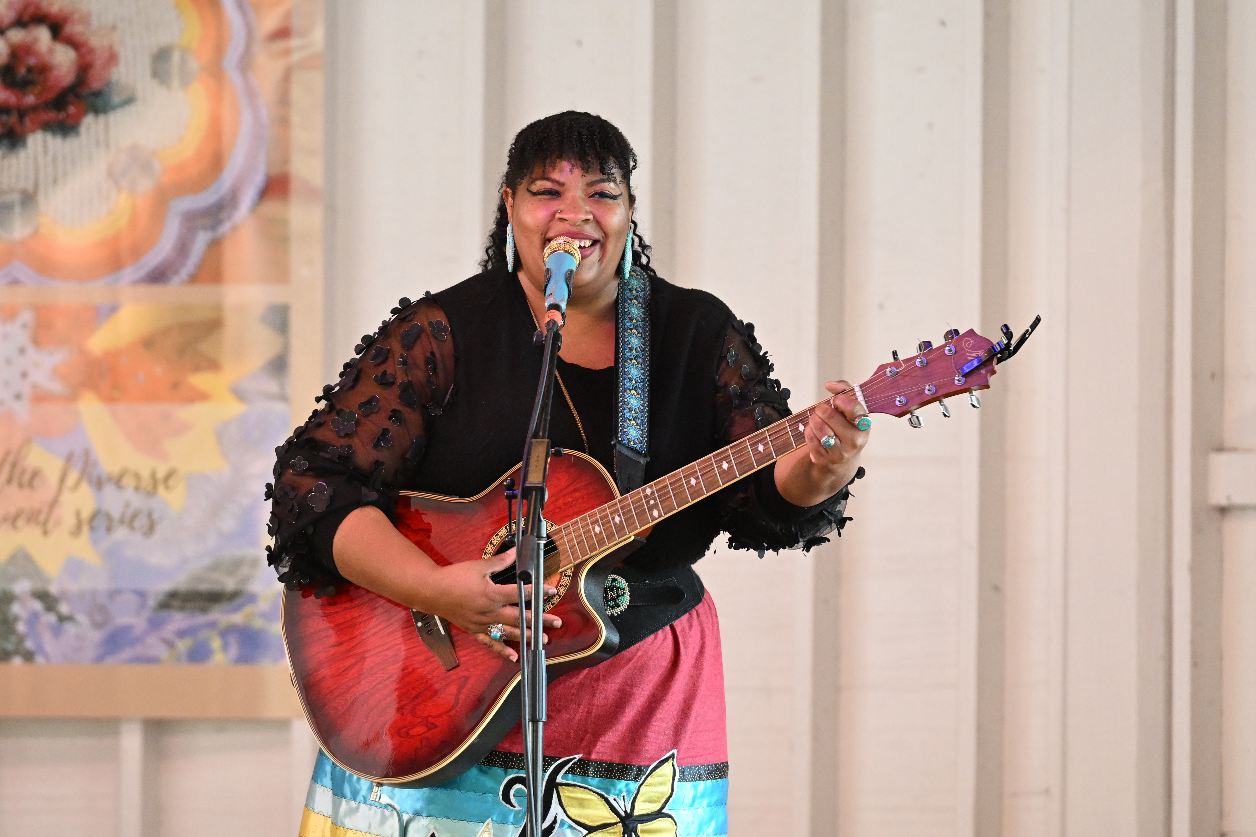 Carly Harvey performs with a guitar