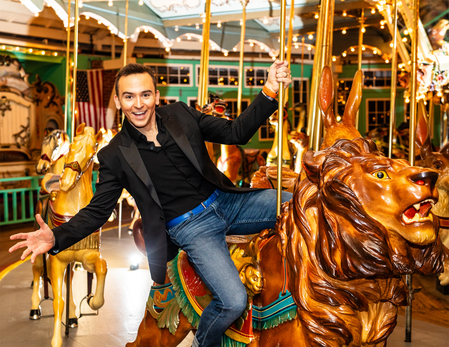 A man sits on a carousel