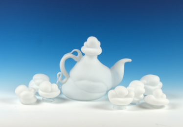 Glass blown teapot with clouds on a blue gradient background