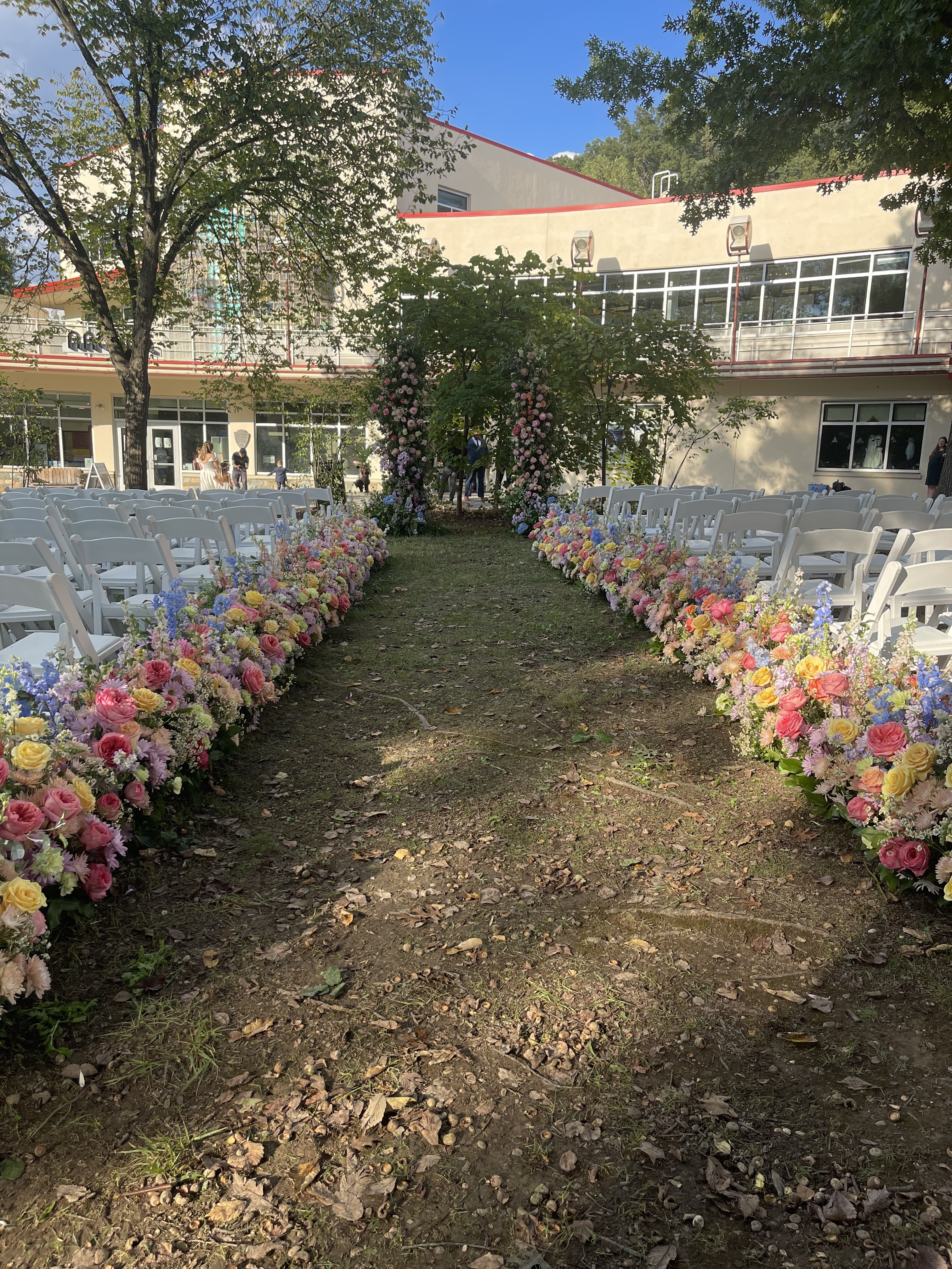 An outdoor wedding ceremony space with flowers