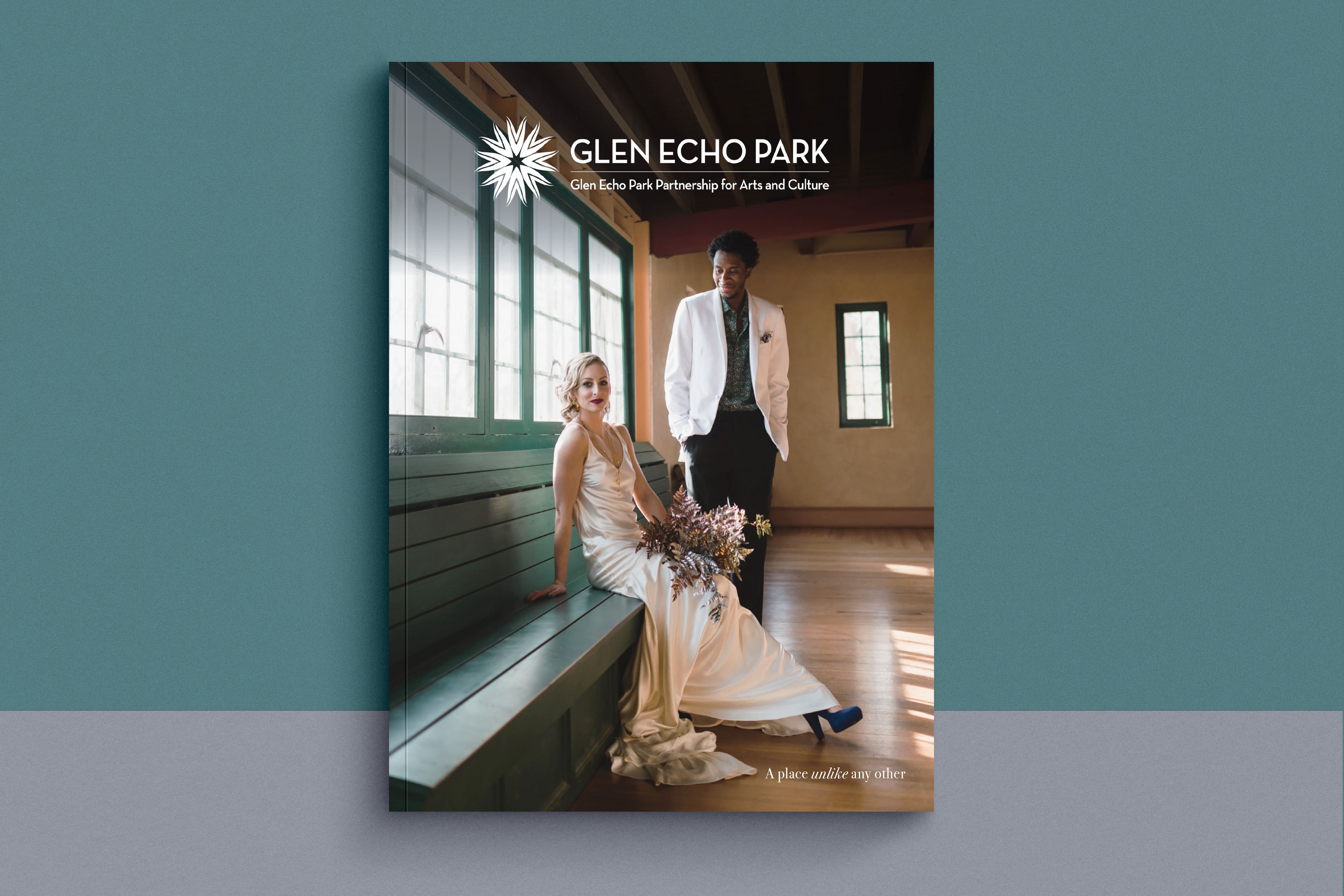 Rentals brochure with bi-racial couple on the cover posed in the Spanish Ballroom. Bride in white dress. Groom in white jacket. 