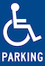 blue background with wheelchair symbol in white and white font saying Parking