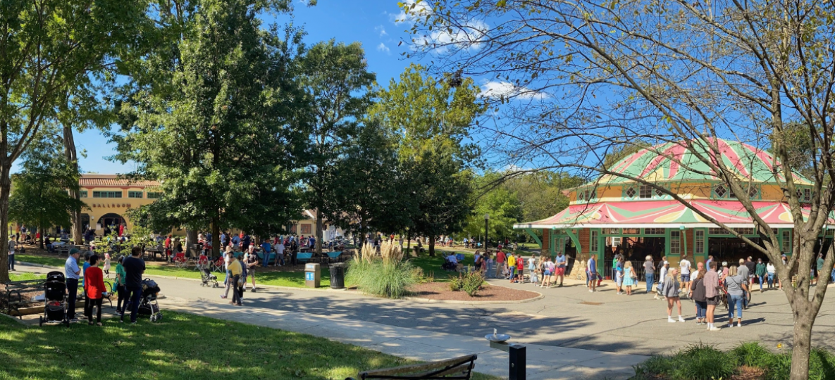 Summer day at Glen Echo Park with visitors, colorful carousel building, and blue sky