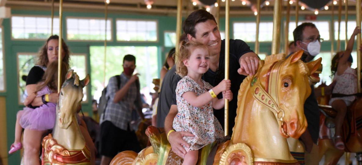 Father and toddler daughter on Glen Echo Park carousel