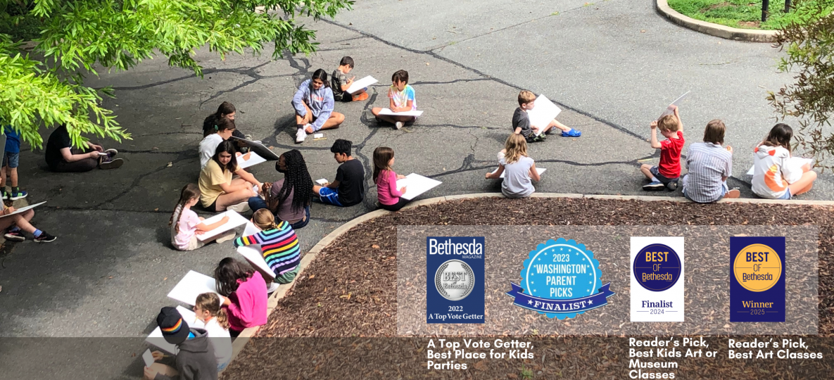 Children sitting outside at the Park with their drawing tablets surrounded by green trees