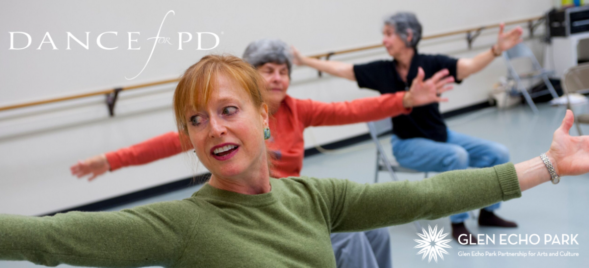 Dancers in chairs in a dance studio