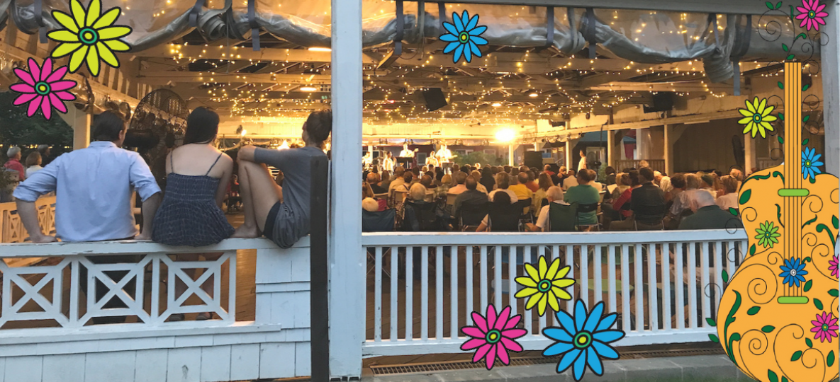 photo of people sitting at the back of the Bumper Car Pavilion on a low white railing with yellow glow in the pavilion and a crowd listening to a concert plus flowers overlay the image