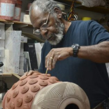 A man works on pottery