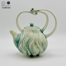 A green ceramic teapot