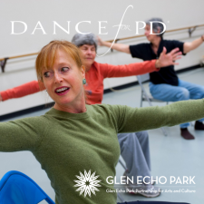 A dancer in a chair with arms outstretched