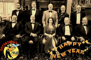 Swing band members seated, men in tuxes, sepia-toned image