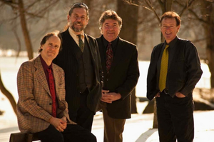 A band stands in the woods