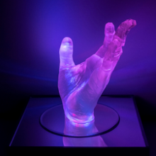 Glowing hand sculpture by Michelle Lisa Herman