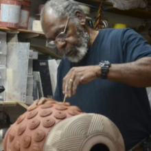 A man works on pottery