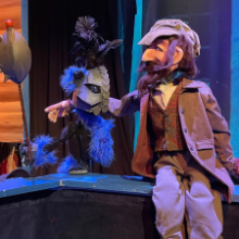 A goblin puppet and a human puppet