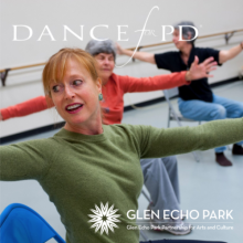 A dancer in a chair with arms outstretched