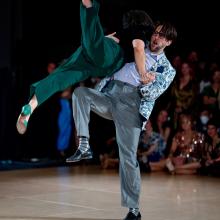 Photo of Dancer lifting other dancer with a high kick