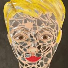 painting of a face made with broken tiles and yellow hair and red lips