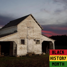 Photo of white house at dusk with Black History Month badge