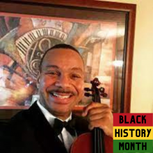 Cleveland Chandler with violin and Black History Month badge